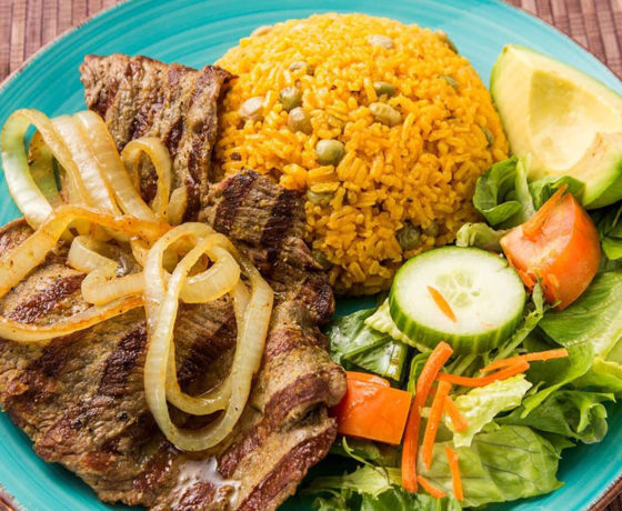 Bistec Encabollado and rice from The Freakin Rican Restaurant in New York City.